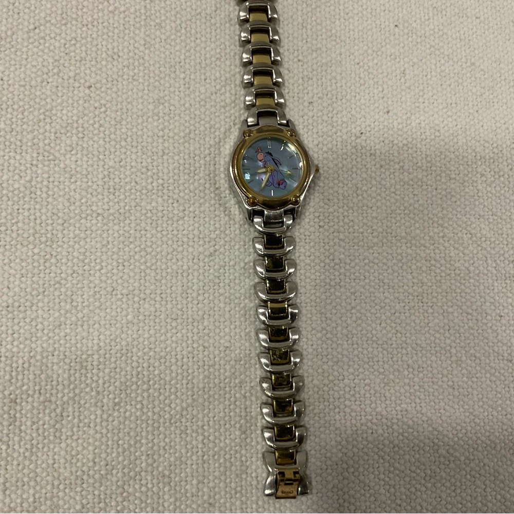 Licensed Disney watch. Eeyore face. Silver hands metal bracelet band. Good cond.